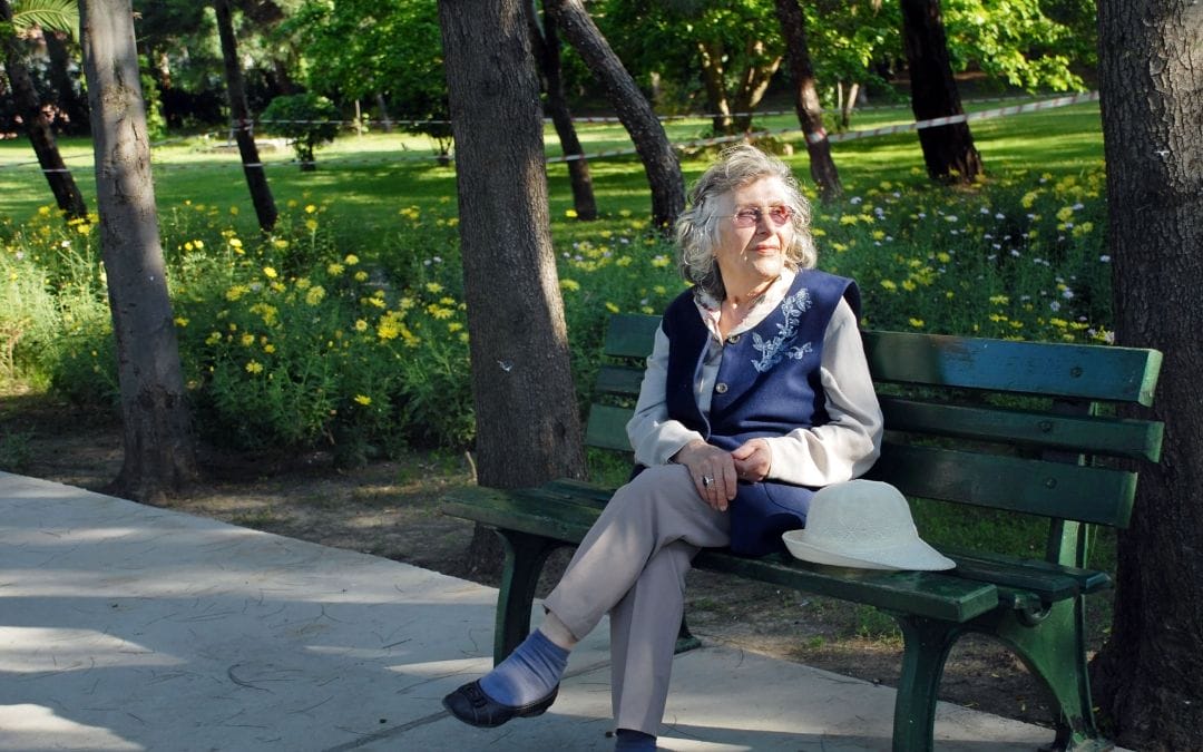 Senior woman sitting on park bench