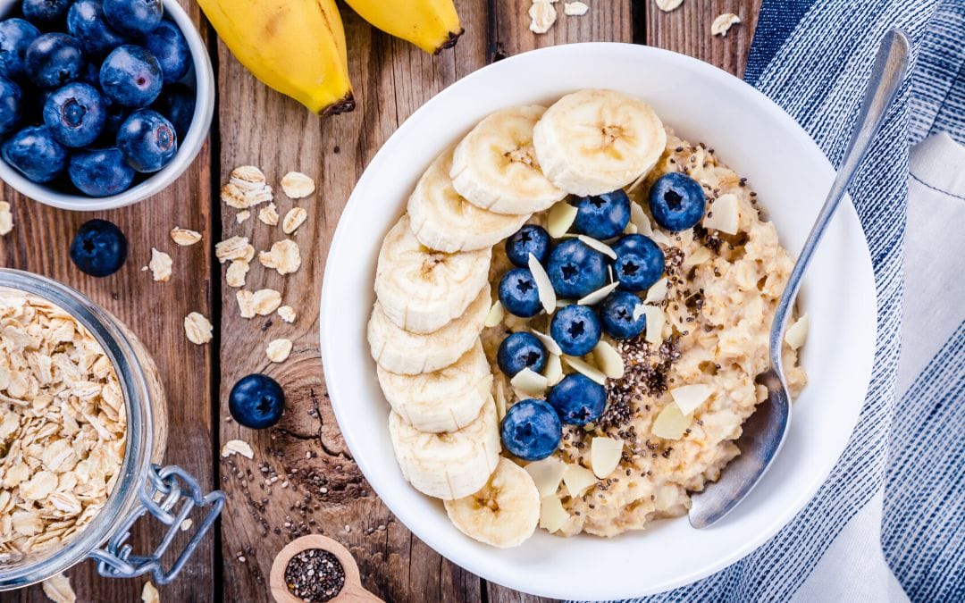 Bowel of banana slices, oatmeal, and blueberries