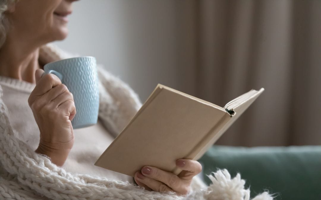 Senior woman reading with coffee