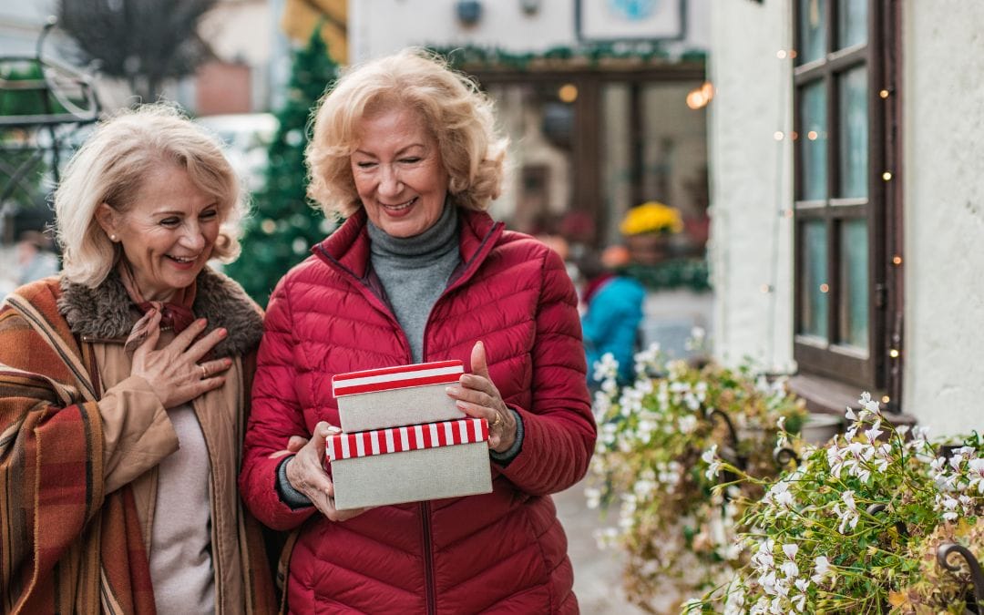 Elderly women walking and laughing outside holiday shopping
