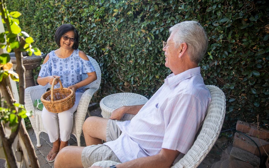 Elderly couple chatting outside