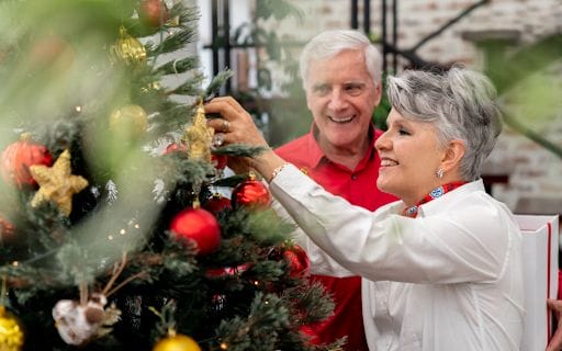 Senior couple decorating Christmas tree